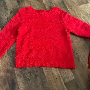 red sweater idk the brand but it’s a small